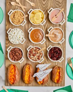 a wooden table topped with lots of different foods and utensils on top of it