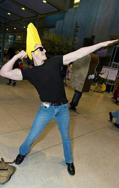 a man in black shirt holding a banana over his head