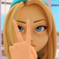 a close up of a doll making the peace sign with her hand and wearing a green headband