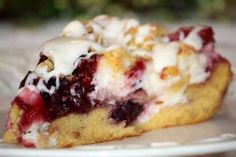 a piece of pie on a plate with icing and strawberries in the middle