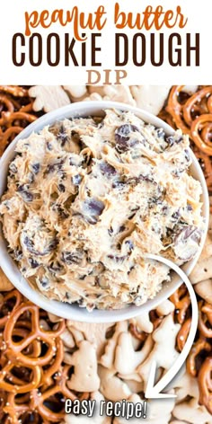 a bowl filled with cookie dough surrounded by pretzels