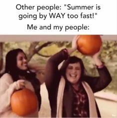 two women are holding pumpkins in their hands