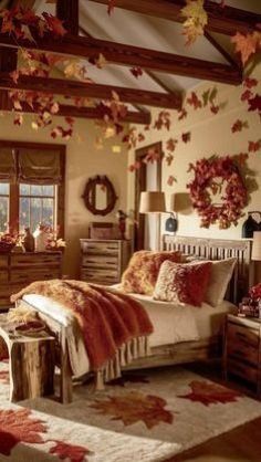 a bedroom decorated in fall colors with red and orange leaves falling from the ceiling,