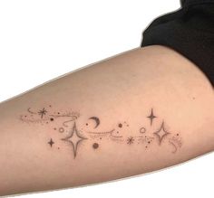 a woman's arm with stars and crescents on it, in black ink