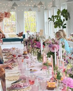 a group of people sitting around a table with food