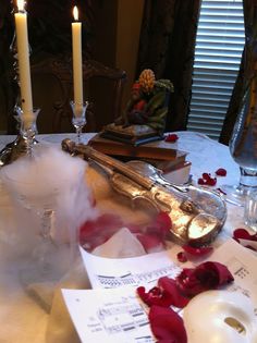 a table topped with paper and candles