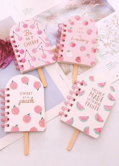 four pink notebooks with watermelon designs on them