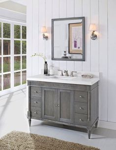 a bathroom with a sink, mirror and rug