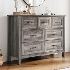 a dresser with drawers and a mirror above it