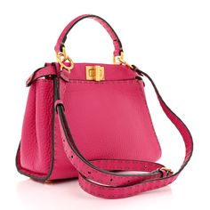 This is an authentic FENDI Calfskin Romano Mini Selleria Peekaboo Iconic Satchel in Fuchsia. This satchel is crafted of calfskin leather in pink. It features a sturdy handle, gold hardware including handle links and a top interior structured frame. The bag also features a gold turn lock on each side opening to a suede lining with a zipper and patch pocket. Gold Hardware, Patch Pocket, Calf Skin, Satchel, Fendi, Zipper, Frame, Leather, Pink