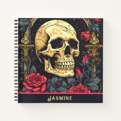 a spiral notebook with a skull and roses on it