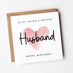 a card with the words husband written on it and a pink heart in the middle