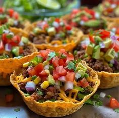 taco cups filled with meat, cheese and vegetables