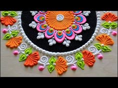 an intricately decorated black and white circular with colorful flowers on it's surface