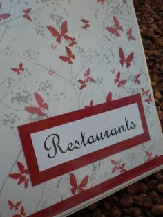 a red and white restaurant sign sitting on top of beans