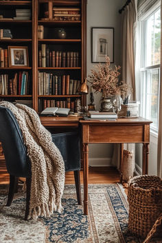 a chair sitting in front of a book shelf filled with books next to a window