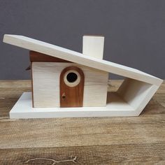 a wooden birdhouse with a door and window