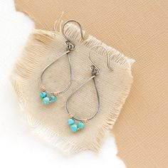 Delicate forged teardrop shaped hoops are adorned with tiny turquoise wrapped in gold wire. I love the contrast of metals and the elegant form of these earrings. Measure 1 7/8". Handmade shepherd hook earwires. 14k gold fill and sterling silver, which has been oxidized and hand polished for an antique finish. About turquoise: The name turquoise means "Turkish stone" because the trade route that brought it to Europe came via Turkey. Turquoise is a non-translucent stone of which the most valuable Turquoise Teardrop Hoop Earrings Nickel Free, Turquoise Teardrop Nickel-free Hoop Earrings, Teardrop Turquoise Nickel-free Hoop Earrings, Nickel-free Teardrop Turquoise Hoop Earrings, Nickel-free Turquoise Teardrop Hoop Earrings, Turquoise Teardrop Earrings Wire Wrapped, Turquoise Wire Wrapped Teardrop Earrings, Teardrop Hoop Earrings, Hoop Earrings Handmade