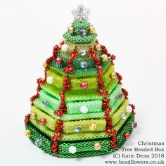 a small christmas tree made out of beads