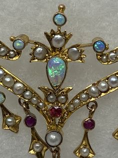 "Antique Art Nouveau 9Kt Opal, Ruby and Pearl Necklace. Approximate measurements: length of chain end to end 14 1/2\", center piece 70mm x 41mm. This 9Kt Opal, Ruby and Pearl necklace has been professionally appraised for $4500.00 and that written appraisal will accompany the necklace when sold. Since I am not an expert regarding this item, I have relied on the expertise of the certified professional appraisal. The following details about this Art Nouveau necklace are from a Certified Gemologist Luxury Art Nouveau Formal Necklaces, Art Nouveau Pearl Jewelry, Art Nouveau Yellow Gold Gemstone Necklaces, Collectible Art Nouveau Gold Jewelry, Gold Art Nouveau Necklace With Gemstone, Art Nouveau Necklaces, Chocolate Color, Champagne Diamond, Opal Crystal