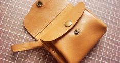 a brown leather pouch sitting on top of a table