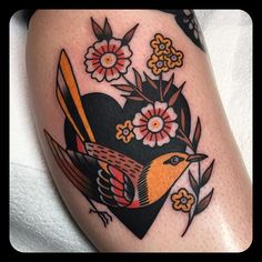 a bird with flowers on it's back leg