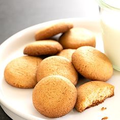 some cookies and a glass of milk on a plate