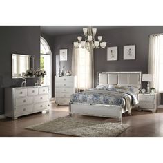 a bedroom with gray walls and white furniture