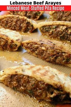 some meat stuffed pita breads on a baking sheet