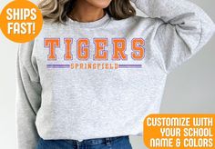 Stay cozy and show your team pride with our Custom Team Mascot Sweatshirt! Perfect for game days, casual outings, or lounging at home Crafted from high-quality, ultra-soft fabric, this sweatshirt offers unbeatable comfort and warmth. It's customizable with your choice of colors and team/city name, making it a unique and personal piece of fan gear. Whether you're cheering from the stands or representing your team around town, this versatile sweatshirt is a stylish way to display your loyalty. It's also an excellent gift for sports enthusiasts who love to support their favorite team in comfort and style. Order your custom Comfort Colors sweatshirt today and celebrate your team spirit with flair! Production Time: 1-3 business days Shipping Time: 2-5 business days We GUARANTEE all of our produ Collegiate Style Tops In Athletic Heather For Game Day, Collegiate Athletic Heather Tops For Game Day, Collegiate Sweatshirt With Team Logo, Sporty College Sweatshirt With Team Logo, Long Sleeve University Logo Tops For Sports Season, Collegiate Style Sweatshirt For Sports Events, Long Sleeve Tops With University Logo For Sports Season, University Logo Long Sleeve Tops For Sports Season, University Logo Tops For Sports Events