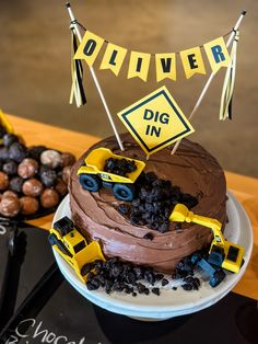 a birthday cake with construction vehicles on it