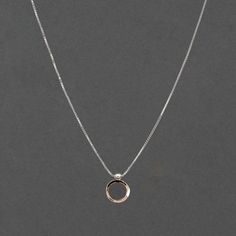 The ellipse form and circle come together in an arrangement that suggests a shell, a pearl or the symbol of Venus, creating a striking charm necklace that you'll love wearing everyday. This combination is timeless with the mixed metal elements of the gold hammered circle and silver ellipse form which slides along the glittering box chain. The charm is 5/8" long and 1/2" wide. This necklace has a 2" adjustable station so you may easily adjust the lengths. The model is shown wearing the 16/18" at 16" in the first picture and 18" in the second. FORM Collection Each piece of Haley Lebeuf Jewelry is individually crafted in the Austin, Texas studio. Pieces will have slight variations due to the nature of items made by human hands. Great effort is put into each item to ensure the highest quality, Mixed Metal Jewelry, Charm Necklace Silver, Argentium Silver, Modern Necklaces, Gold Price, Mixed Metals, Aphrodite, Box Chain, Silver And Gold