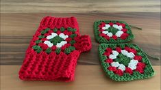 two crocheted oven mitts and one pot holder on a wooden table top