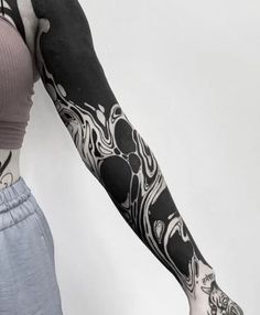 a woman with black and white tattoos on her arm