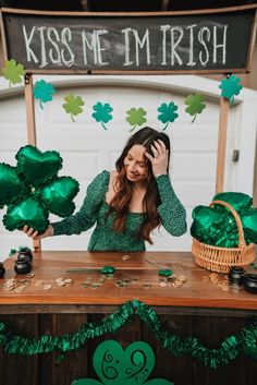 a woman sitting at a table with shamrock decorations