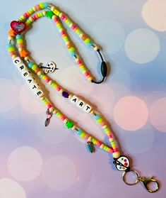 A unique and fun way to show off your Art teaching skills with this fun handmade beaded lanyard! Product Details: ❤️ Perfect for Teachers or someone who loves Art! 🎨🖌️🖼️ ❤️ Available Size: Standard: 19 inchesLong: 23 inches ❤️ Handmade: Nylon String, Beads, Silicone Bead, and Breakaway Clasp Fun Beaded Craft Supplies For Gifts, Playful Multicolor Beaded Craft Supplies, Colorful Adjustable Fun Beaded Necklaces, Adjustable Multicolor Bohemian Lanyards, Playful Multicolor Handmade Craft Supplies, Playful Handmade Multicolor Craft Supplies, Bohemian Handmade Lanyards As Gifts, Colorful Handmade Craft Supplies, Multicolor Personalized Lanyards With Round Beads