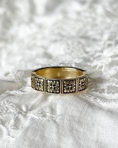 The Fleur Ring, the perfect French Girl staple in honor of Spring! Bringing a Victorian style to the daisy chain, this ring is gorgeous alone or stacked with other rings in your collection. A beautiful 18kt gold plated silver fleur pattern. Ring Sizes: 6,7,8 Dainty Gold Flower Stackable Rings, Elegant Gold Stackable Flower Ring, Elegant Stackable Brass Midi Rings, Classic Gold Flower Ring For Promise, Vintage Gold Stackable Promise Rings, Gold Flower Heirloom Jewelry, Vintage Yellow Gold Promise Flower Ring, Heirloom Gold Flower Jewelry, Gold Open Ring Flower Fine Jewelry