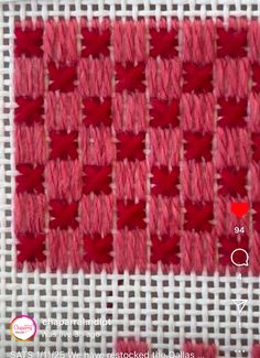 red and white crochet stitchs on the side of a piece of cloth