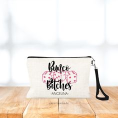 This personalized bunco bitches wristlet is the perfect bunco bag accessory. It features a convenient zipper pouch to hold your money and other bunco essentials. This custom name bag makes the perfect gift for the bunco lover in your life!  Colors change be changed, just make note in the personalization box. Don't forget to add on a matching coin purse! DETAILS: ➤ Designs are professional printed using high quality inks to prevent fading, cracking or peeling. ➤ Large Bag is Approximately 8.75" x Pouch Wristlet With Zipper Closure For Gift, Gift Wristlet With Zipper Pouch, Zipper Pouch Wristlet For Gift, Zipper Pouch Wristlet As Gift, Wristlet Zipper Pouch As Gift, Adjustable Clutch Bag As Gift, Adjustable Clutch Bags As Gifts, Rectangular Wristlet With Zipper Pouch As Gift, Bunco Gifts