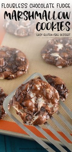 chocolate fudge marshmallow cookies on a cookie sheet with a fork in the foreground