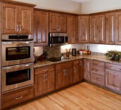 a kitchen with wooden cabinets and stainless steel appliances