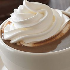 there is a cup of hot chocolate with whipped cream on top