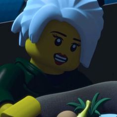 the lego man is sitting next to a banana