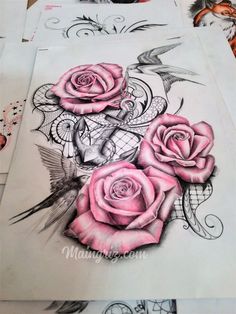 some pink roses are sitting on top of paper