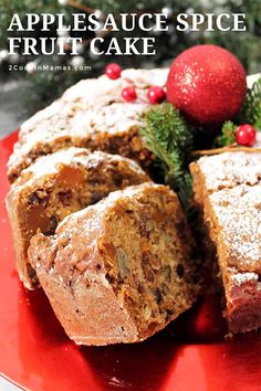 a red plate topped with fruit cake next to a christmas tree