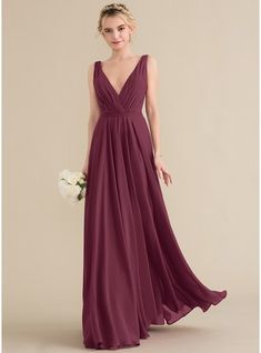 a bridesmaid in a long, deep - purple dress with a v - neckline