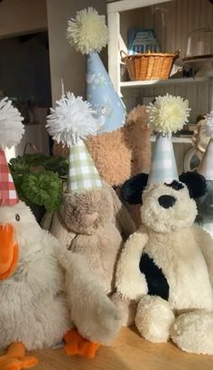 several stuffed animals wearing party hats on a table