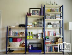 a living room filled with lots of books and furniture