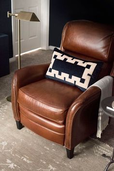 a chair with a pillow on it in a living room