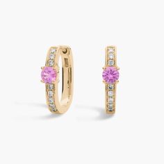 Summon second glances in these elegant hoop earrings featuring a front-facing pink sapphire set in each hoop. Brilliant accent diamonds shimmer along the front of each 14k white gold hoop, adding eye-catching brilliance. White Gold Hoops, Diamond Hoop Earrings, Precious Gemstones, Gold Hoop, Pink Sapphire, Gemstone Earrings, Gemstone Jewelry, Sapphire, Jewelry Earrings